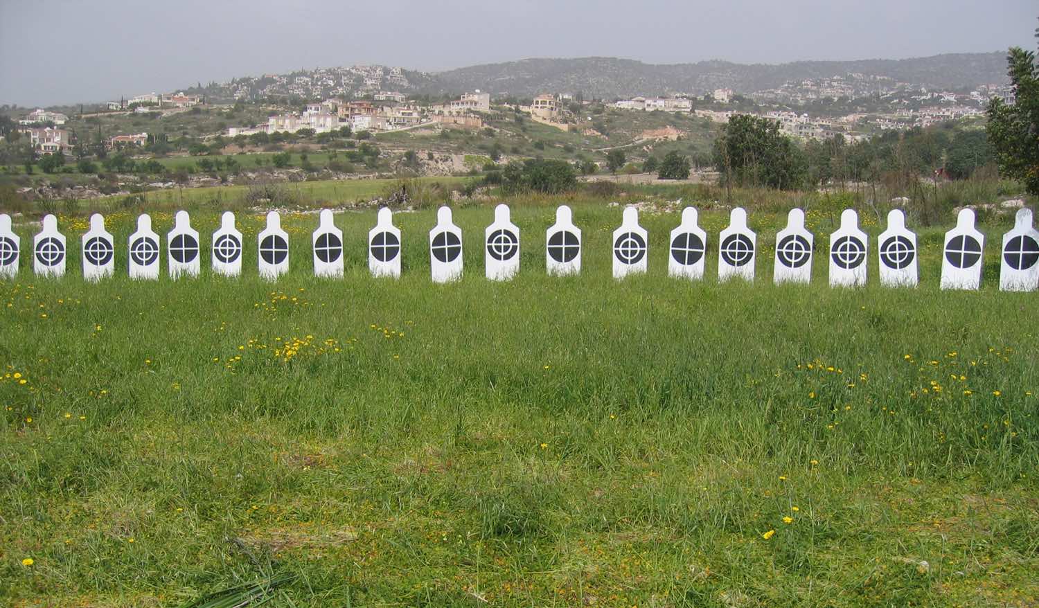 White human figures in line with black targets on their chest