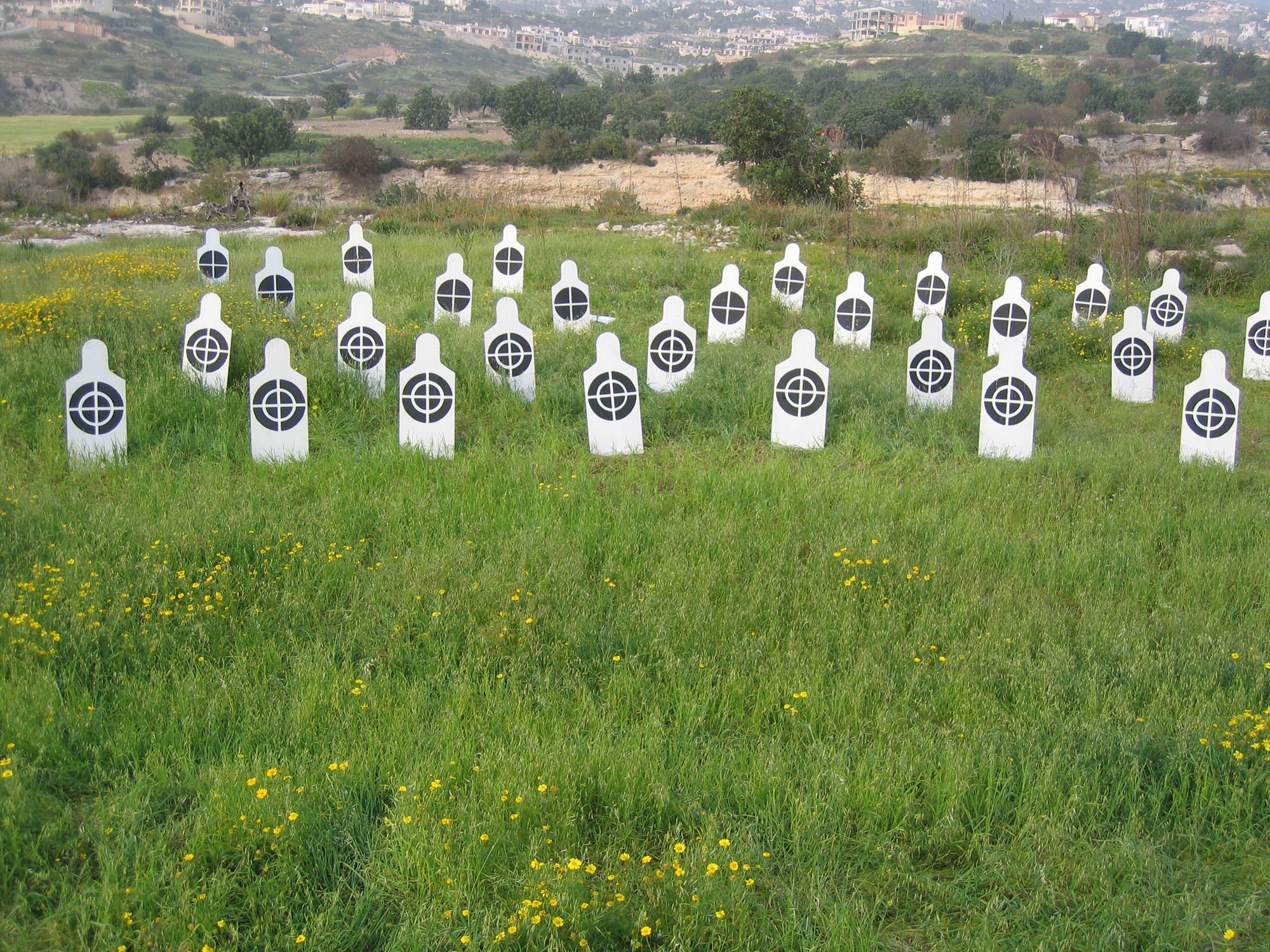 White human figures in line with black targets on their chest