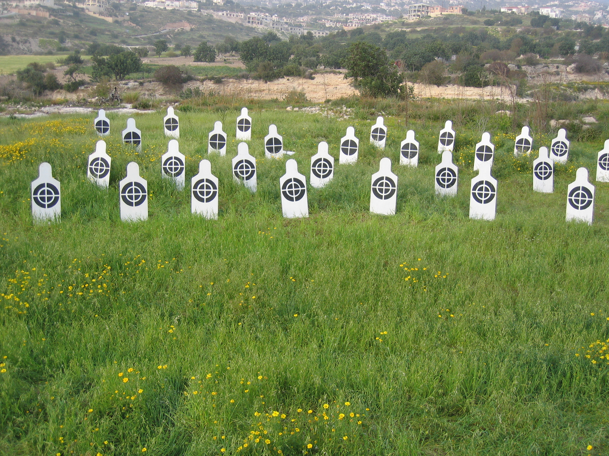 White human figures in line with black targets on their chest