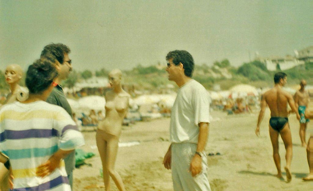 The artist talking to people at the beach